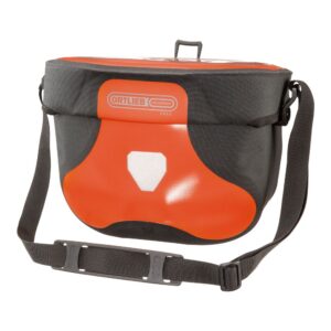 an Ortlieb Ultimate Six Free handlebar bag is shown in a Rust & black waterproof material with a black shoulder strap visible.