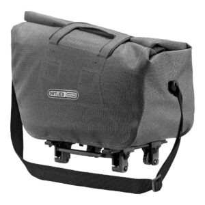 An Ortlieb Trunk-Bag RC Urban waterproof rack-top bag is shown in a pepper grey Cordura fabric with a black shoulder strap, roll-top closure & a black adapter for mounting on the bike's rack