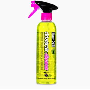A bottle of Muc-Off Bio Drivetrain Cleaner is shown with a bright pink nozzle and radioactive yellow liquid inside