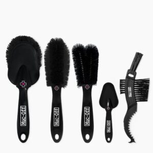 A Muc-Off 5x Premium Brush Set is shown with the 5 brushes laid out on a white surface