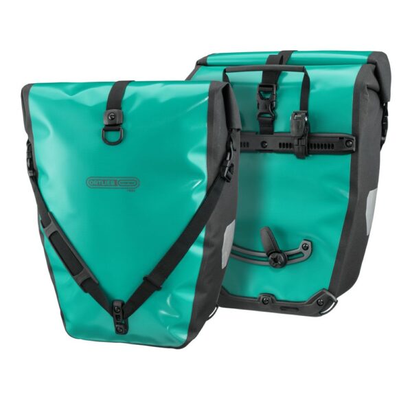 a pair of Ortlieb Back-Roller Free rear panniers shown back to back in a lagoon green & black colourway, showing the mounting hardware on one pannier & a shoulder strap on the other