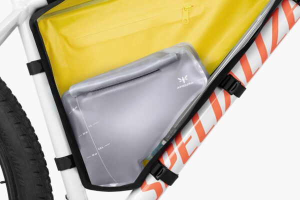 An Apidura Frame Pack Hydration Bladder is shown inside a frame bag mounted to a bicycle's main triangle