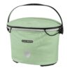 An Ortlieb Up Town City handlebar bag in the style f a basket is shown in a light green colourway in waterproof material