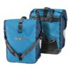 a pair of Ortieb Sport-Roller Plus front panniers in a light & dark blue colourway showing their mounting hardware & shoulder strap