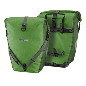 a pair of Ortlieb Back-Roller Plus rear panniers shown in a kiwi-moss green colourway, with the rear mounting hardware visible on one and the shoulder strap on the other