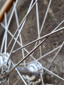 The shining Silver Spokes & hub of a hand built wheel are shown