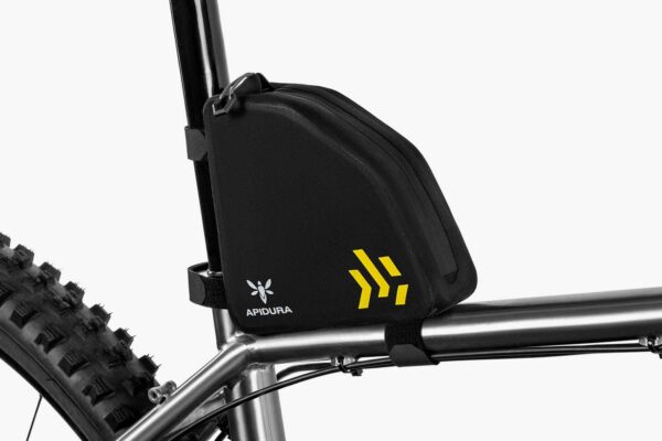 an Apidura Baackcountry Rear Top Tube pack is shown attached via velcro strapping to the seat post & toptube of a bicycle