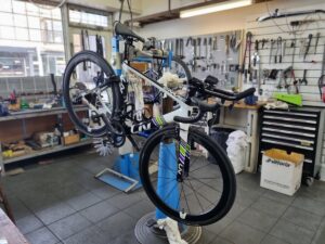 An Aero bicycle is shown in a workstand in the workshop having a Comprehensive Service performed on it