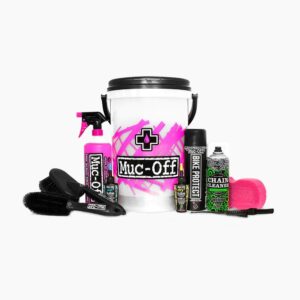 The Muc-Off Dirt Bucket Kit is shown with the contents of the kit sitting around the bucket itself, including brushes, cleaners & chain lube for your bicycle