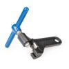 A blue handled Park Tool Chain Tool is shown with a black cast steel body & replaceable driving pin visible.