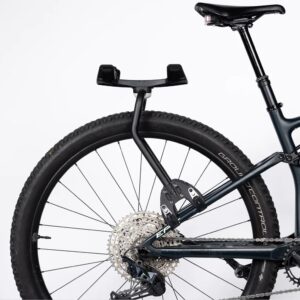 An Aeroe Spider Rear Rack is shown in black powder finish fitted to the seat stays of a dual suspension mountain bike